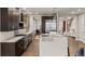 Open concept kitchen with a large island, stainless steel appliances, and hardwood floors at 32 Jackson St, Denver, CO 80206