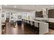 Open-concept kitchen featuring a spacious island, dark wood cabinets, and an adjacent living area with fireplace at 32 Jackson St, Denver, CO 80206