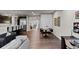 Spacious living room with hardwood floors, modern lighting, and access to dining area at 32 Jackson St, Denver, CO 80206