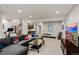 Finished basement living room featuring a sectional couch, TV area, and exercise equipment space at 32 Jackson St, Denver, CO 80206