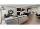 Open-concept living room and kitchen with hardwood floors, modern lighting, and stainless steel appliances at 32 Jackson St, Denver, CO 80206