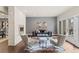 Bright living room with a modern fireplace, hardwood floors, stylish decor, and French doors to the balcony at 32 Jackson St, Denver, CO 80206