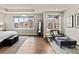 Bright main bedroom featuring hardwood floors, neutral decor, sitting area, and large windows at 32 Jackson St, Denver, CO 80206