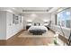 Serene main bedroom features a tray ceiling, built-in wardrobe, and large windows at 32 Jackson St, Denver, CO 80206
