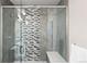 Modern shower stall with glass door, bench, rainfall shower head, and decorative tile at 32 Jackson St, Denver, CO 80206