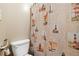 A toilet and roll paper holder with a lighthouse-themed shower curtain at 9650 Huron St # 22, Thornton, CO 80260