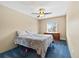 A spacious bedroom with blue carpeting, ceiling fan, and a large window at 9650 Huron St # 22, Thornton, CO 80260
