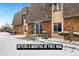 Attractive condo building featuring a stone facade, brown shingle roof and inviting entryway at 9650 Huron St # 22, Thornton, CO 80260