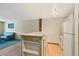 Open layout with modern white appliances and a view into the living area at 9650 Huron St # 22, Thornton, CO 80260