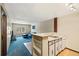 Cozy living room features blue carpeting, a comfortable sofa, and a mini kitchen space at 9650 Huron St # 22, Thornton, CO 80260
