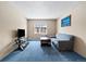 Bright living room featuring carpeted floors, neutral walls, and a comfortable sofa and TV stand at 9650 Huron St # 22, Thornton, CO 80260