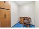 A compact office space shows a wooden desk and chair with blue carpet at 9650 Huron St # 22, Thornton, CO 80260