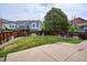 Spacious backyard with lush green grass, patio area, and mature trees at 10060 Oak Leaf Way, Highlands Ranch, CO 80129