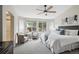 Sunlit main bedroom with a cozy sitting area, large windows, and calming neutral tones for a relaxing retreat at 10060 Oak Leaf Way, Highlands Ranch, CO 80129