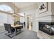 Open dining room boasts vaulted ceilings, an elegant chandelier, and a cozy fireplace at 10060 Oak Leaf Way, Highlands Ranch, CO 80129
