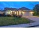 Charming single-story home with a well-manicured lawn and a two-car garage at dusk at 10060 Oak Leaf Way, Highlands Ranch, CO 80129
