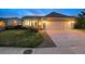 Charming home exterior at twilight with a well-manicured lawn and a spacious three car garage at 10060 Oak Leaf Way, Highlands Ranch, CO 80129