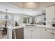 Bright kitchen featuring white tile countertops, stainless steel appliances, and an open layout with backyard access at 10060 Oak Leaf Way, Highlands Ranch, CO 80129