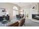 Open-concept living and dining area with modern furniture and a fireplace at 10060 Oak Leaf Way, Highlands Ranch, CO 80129