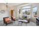 Bright living room featuring large windows, stylish furniture, and neutral decor at 10060 Oak Leaf Way, Highlands Ranch, CO 80129