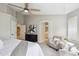 Bright main bedroom featuring a sitting area, ensuite bathroom, and walk-in closet for ample storage at 10060 Oak Leaf Way, Highlands Ranch, CO 80129