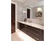 This bathroom features a marble countertop, dark wood cabinets, and stylish light fixtures at 2260 S Jackson St, Denver, CO 80210