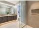 Bright bathroom featuring dual vanities, shower, and open access to toilet at 2260 S Jackson St, Denver, CO 80210