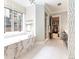This bathroom features a soaking tub with marble surround, glass shower, and private dressing area at 2260 S Jackson St, Denver, CO 80210