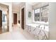 This bathroom features a soaking tub with marble surround and plenty of natural light at 2260 S Jackson St, Denver, CO 80210
