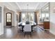 Formal dining room features modern chandelier, neutral colors, and French doors to the backyard at 2260 S Jackson St, Denver, CO 80210