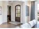 Bright foyer features an arched entry door, hardwood floors, and elegant lighting fixtures at 2260 S Jackson St, Denver, CO 80210