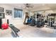 Well-equipped home gym featuring various machines, free weights, and mirrored wall at 2260 S Jackson St, Denver, CO 80210