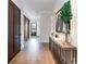 Long hallway features beautiful hardwood floors and dark wood doors at 2260 S Jackson St, Denver, CO 80210