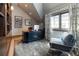 Home office with a built-in bookshelf and comfortable sitting area at 2260 S Jackson St, Denver, CO 80210
