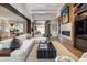 Open living room with a white sofa, fireplace, and seamless access to the outdoors at 2260 S Jackson St, Denver, CO 80210