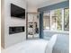 This main bedroom has a fireplace with a TV, mirrored wardrobe and lots of natural light at 2260 S Jackson St, Denver, CO 80210