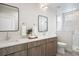 Modern bathroom features a double vanity with framed mirrors and a glass enclosed shower at 1256 Xavier St, Denver, CO 80204