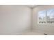 Cozy empty bedroom features neutral carpeting, a large window, and crisp white trim at 1256 Xavier St, Denver, CO 80204
