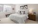 Bright bedroom features neutral decor, plush carpeting, a queen bed, and a window with blinds at 1256 Xavier St, Denver, CO 80204