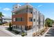 Modern gray exterior with a wood accent wall and a private balcony, located in a vibrant neighborhood at 1256 Xavier St, Denver, CO 80204