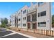 Modern townhome featuring fenced front yard and balconies at 1256 Xavier St, Denver, CO 80204