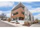 Modern apartment building exterior features private balconies, wood and grey siding, and manicured landscaping at 1256 Xavier St, Denver, CO 80204