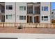Townhome's facade with picket fence and a small garden adds curb appeal at 1256 Xavier St, Denver, CO 80204