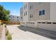 Exterior of townhomes featuring individual garages with ample parking space at 1256 Xavier St, Denver, CO 80204
