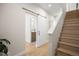 Hallway features wood floors, sliding barn door to bathroom, and staircase to upper level at 1256 Xavier St, Denver, CO 80204