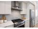 Modern kitchen with stainless steel appliances, gray subway tile backsplash, and white cabinets at 1256 Xavier St, Denver, CO 80204