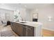 Kitchen island with quartz countertop, stainless dishwasher and sink, plus views into the living area at 1256 Xavier St, Denver, CO 80204