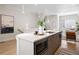 Kitchen island with quartz countertop, modern microwave, and ample sink space with pendant lighting at 1256 Xavier St, Denver, CO 80204
