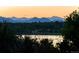 Picturesque mountain range view overlooking a tranquil lake at sunset, offering stunning natural beauty at 1256 Xavier St, Denver, CO 80204
