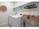 The laundry room features a front load washer and dryer and wire rack shelving at 1256 Xavier St, Denver, CO 80204